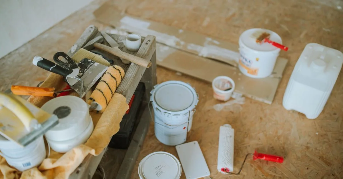 Vue aérienne des outils et des fournitures de peinture pour un projet de rénovation domiciliaire.